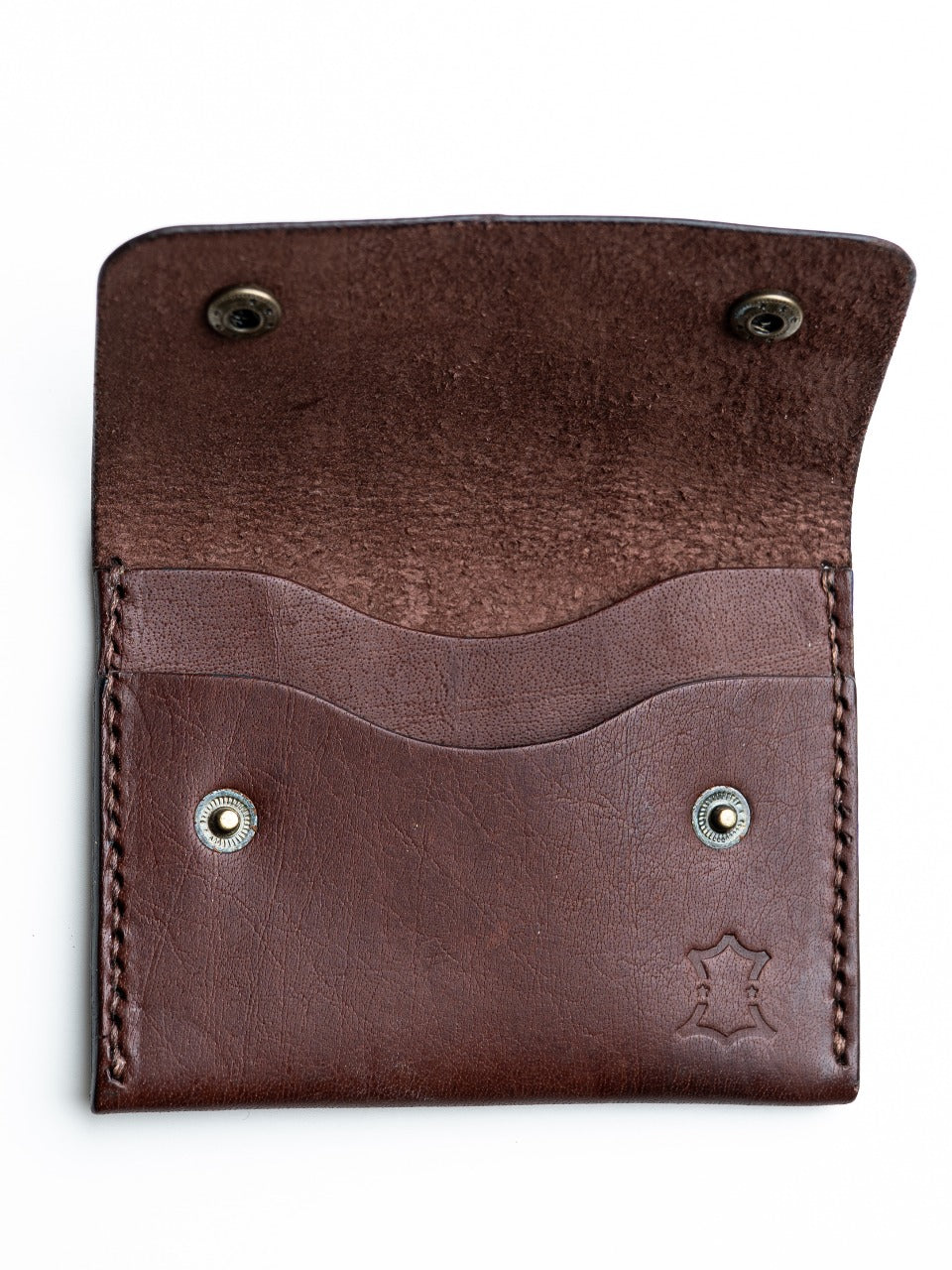 Brown leather wallet EDC with metal grommets on a white background