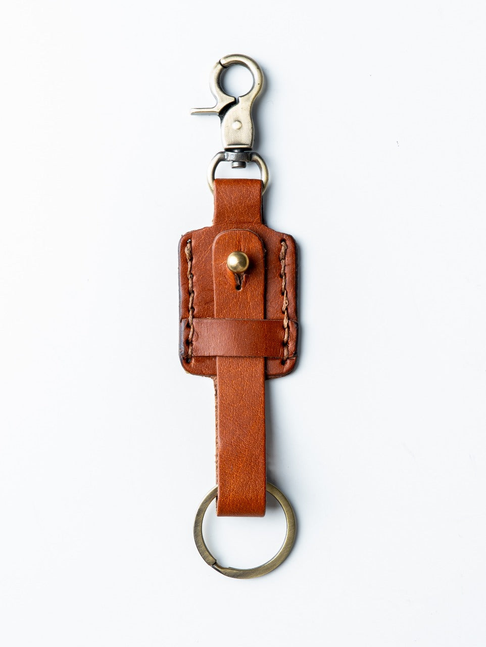 Brown leather key fob with a clip on a white background