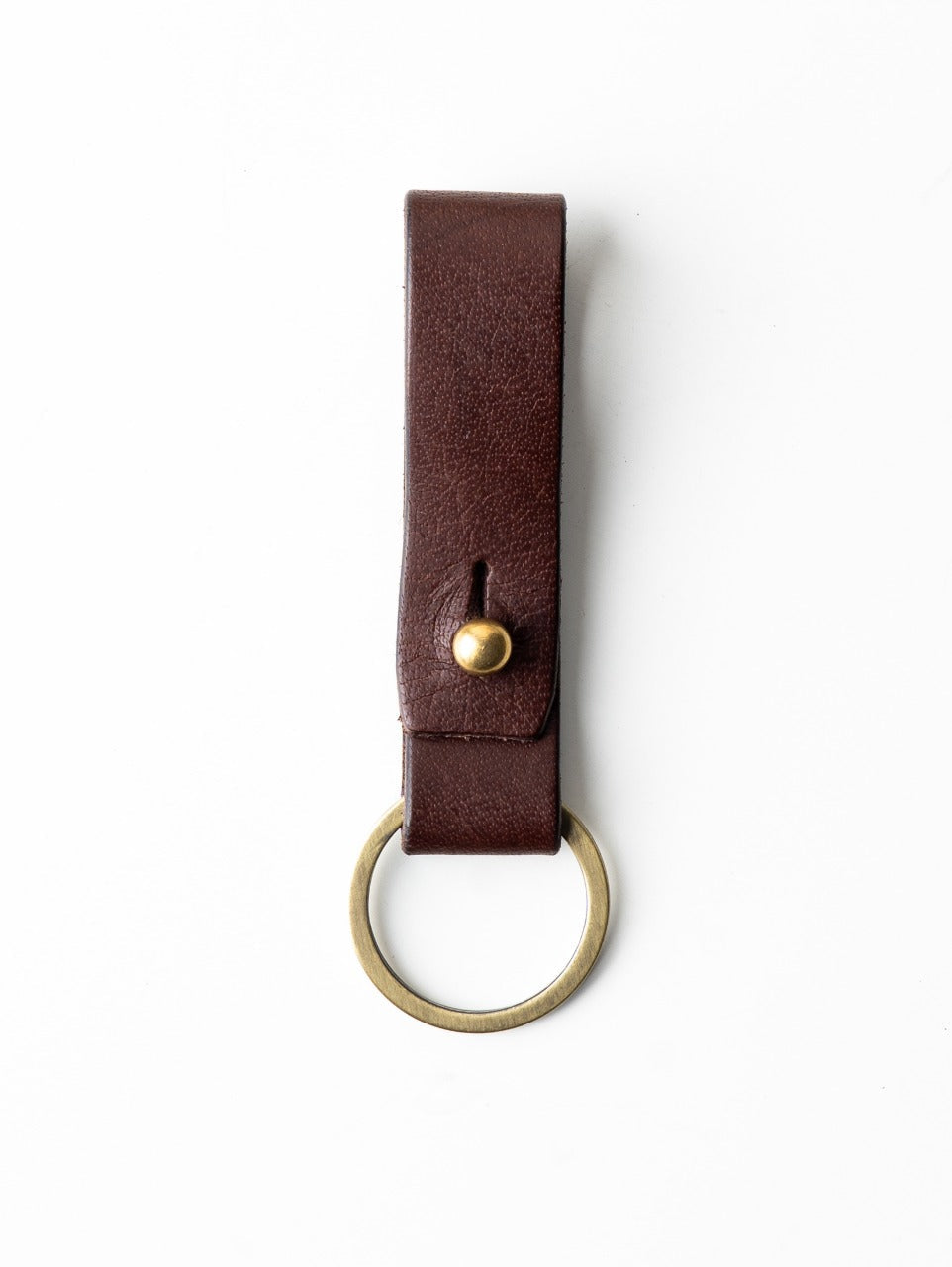 Brown leather key fob with gold accent on a white background
